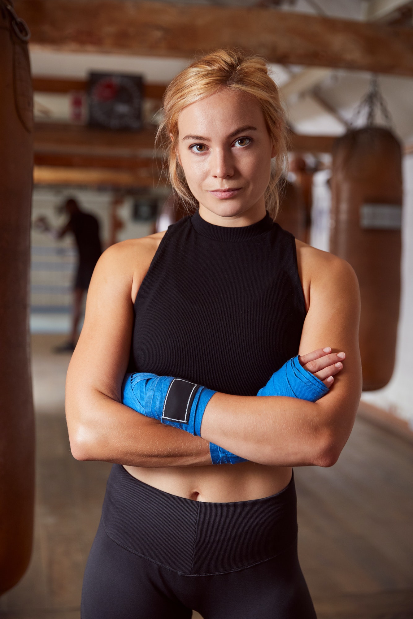 portrait-of-female-boxer-with-protective-wraps-on-hands-training-in-gym.jpg